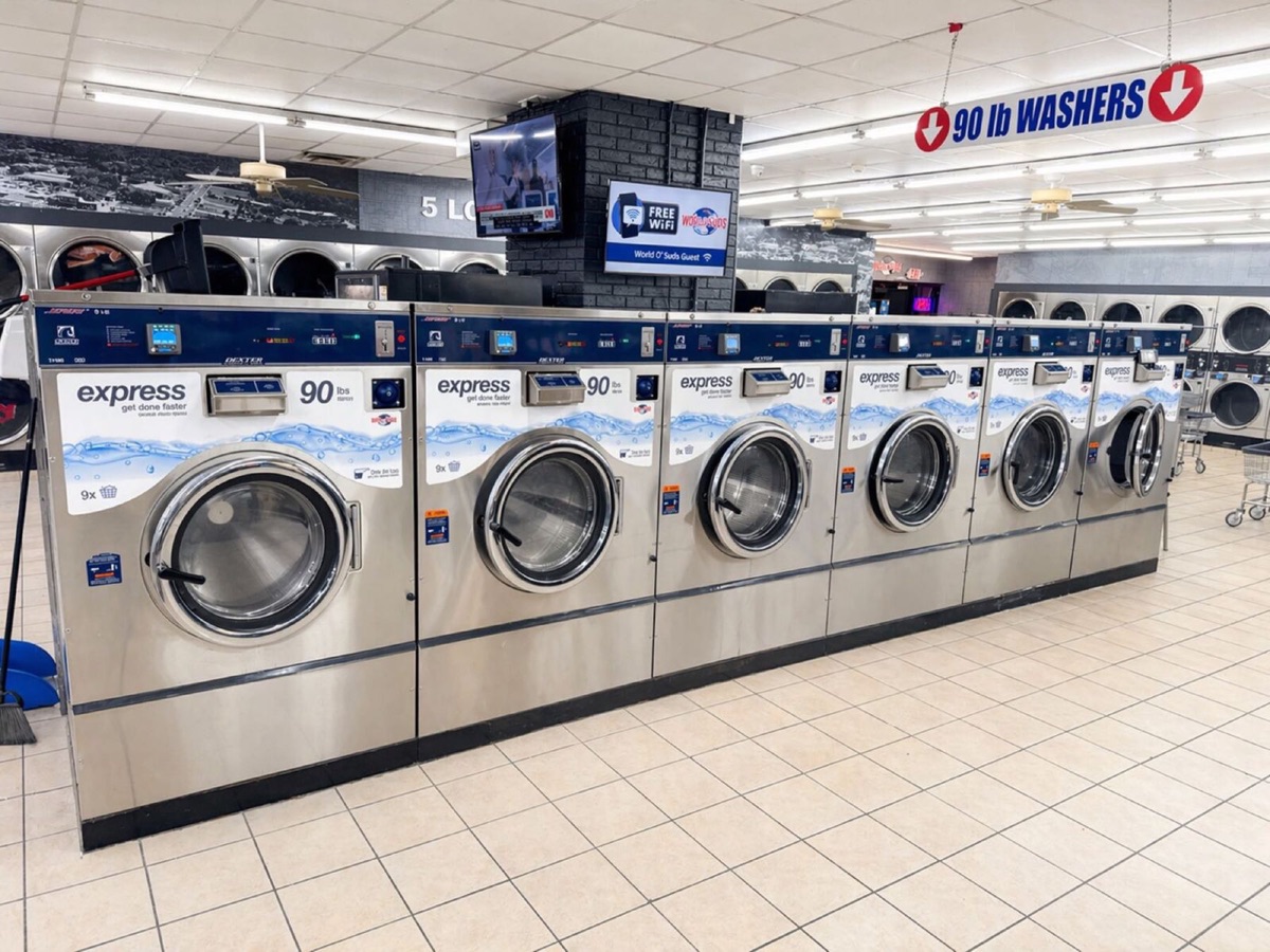 World O' Suds Coin Laundry, 430 E Main St Apopka FL — six Dexter Express 90 lb washers beneath the red 90 lb WASHERS overhead sign